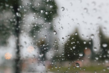 Close-up of Rain drops in front of the car mirror