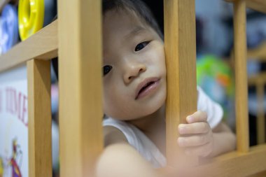 Portrait image of 1 to 2 years old childhood child. Face of relax and happy Asian boy in head shot.