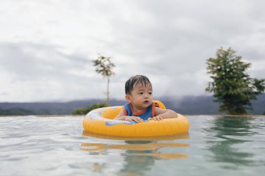 1-2 yaş arası, mutlu ve bilardo oynayan bir çocuğun portresi.