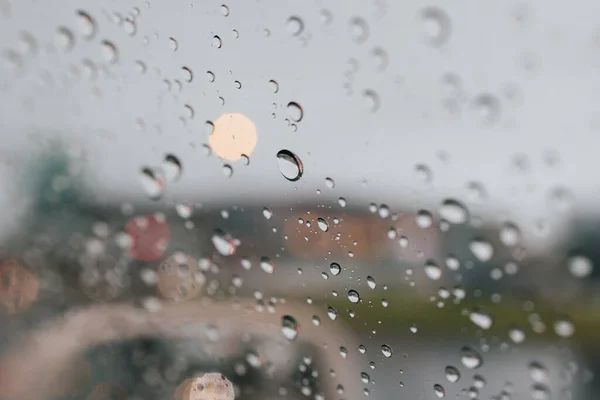 Close-up of Rain drops in front of the car mirror