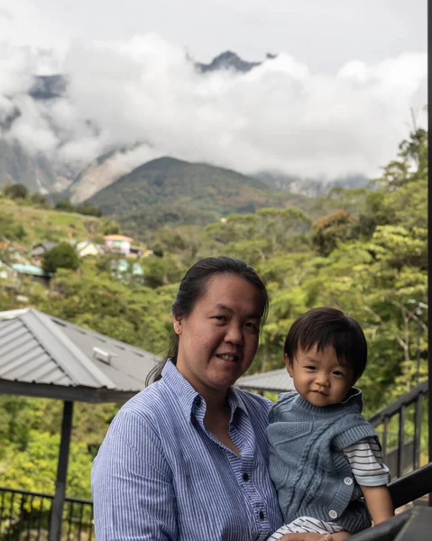 Portrait image of Asian Chinese mother with Happy 1 to 2 years kids during holiday at Kundasang Town, Sabah, Borneo