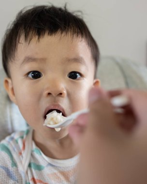 Happy 1-2 years old child enjoying his lunch