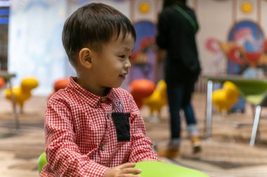 2 yaşındaki sevimli bir çocuğun havalimanında bebek arabasında otururken saf mutlulukla çekilmiş yürek ısıtan bir portresi.