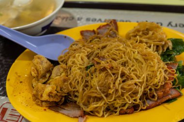 A tantalizing plate of Singapore's iconic Wan Tan Mee, showcasing the perfect balance of flavors that make this dish a beloved local treasure clipart