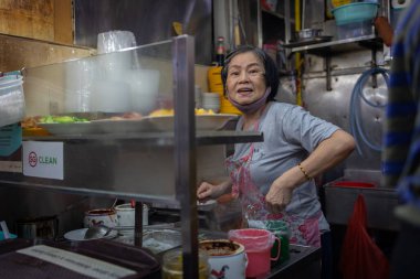 Singapur - 13 Kasım 2022: Singapur 'daki Boon Keng Hawker Center' ın hareketli sahneleri günlük anların ve lezzetlerin zengin duvar halılarını yakalıyor.