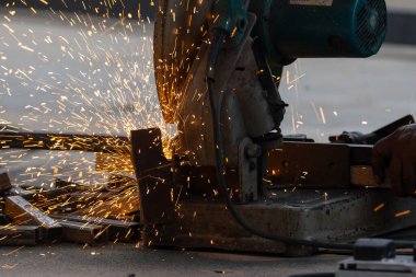 Adam metal tüpü kesmek için testere kesme makinesi kullanıyor.