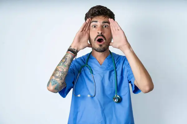 Handsome Nurse Man Wearing Surgeon Uniform White Background Scared Expression — Stock Photo, Image