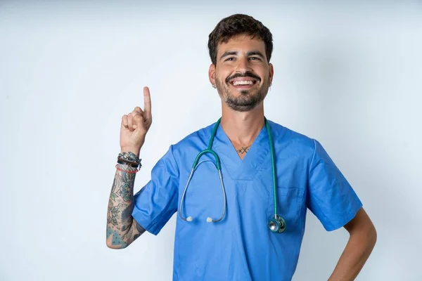 Handsome Nurse Man Wearing Surgeon Uniform White Background Holding Finger — Stock Photo, Image