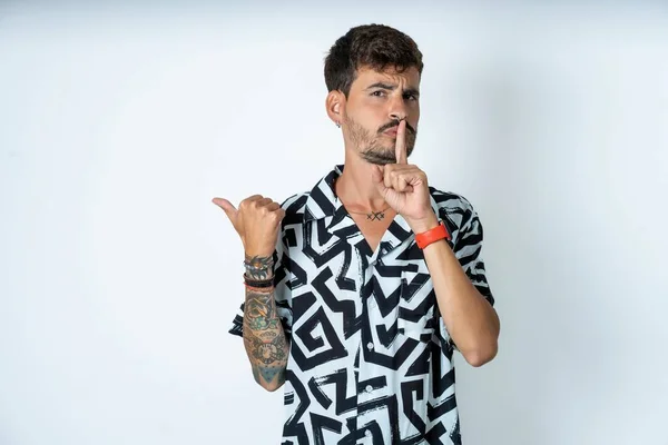 Young Caucasian Man Wearing Printed Shirt Asking Quiet Finger Lips — Stock Photo, Image