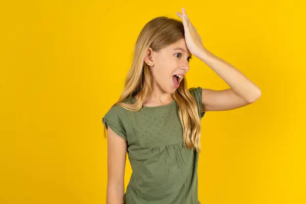Blond Little Girl Wearing Khaki Blouse Yellow Background Surprised Hand — Stock Photo, Image