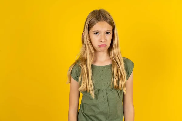 Displeased Upset Blond Little Girl Wearing Khaki Blouse Yellow Background — Stock Photo, Image