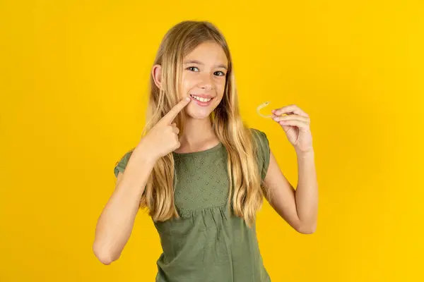 Blond Meisje Draagt Kaki Blouse Gele Achtergrond Met Een Onzichtbare — Stockfoto