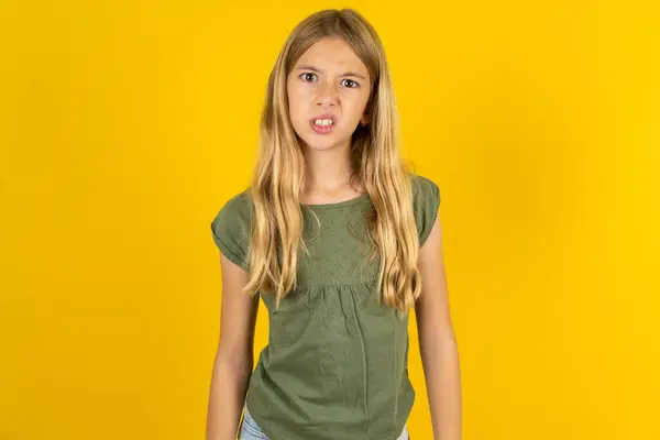 Portrait Dissatisfied Blond Little Girl Wearing Khaki Blouse Yellow Background — Stock Photo, Image