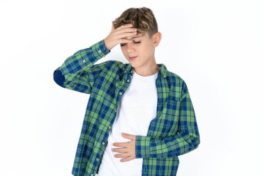 Beyaz arka planda ekose gömlek giyen yakışıklı genç çocuk hastalık ve ateş için alnına dokunuyor, grip ve soğuk algınlığı, virüs hastalığı..