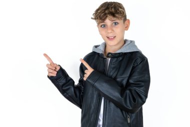 Deri ceketli yakışıklı çocuk fotokopi odasındaki beyaz stüdyo arkaplanlarına poz veriyor. Bu da reklam için doğru yönü gösteriyor.