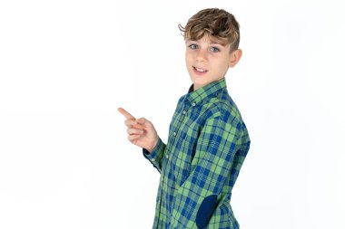 Profile photo of handsome teen boy wearing plaid shirt over white background indicate finger empty space offer clipart