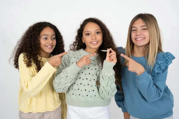 Three Young Multiracial Kid Girls Holding Invisible Aligner Braces Standing — Stock Photo, Image