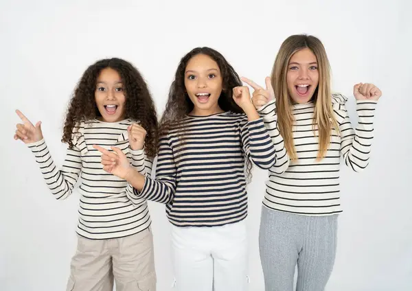 Three Young Beautiful Multiracial Kid Girls Points Empty Space Holding Stock Photo