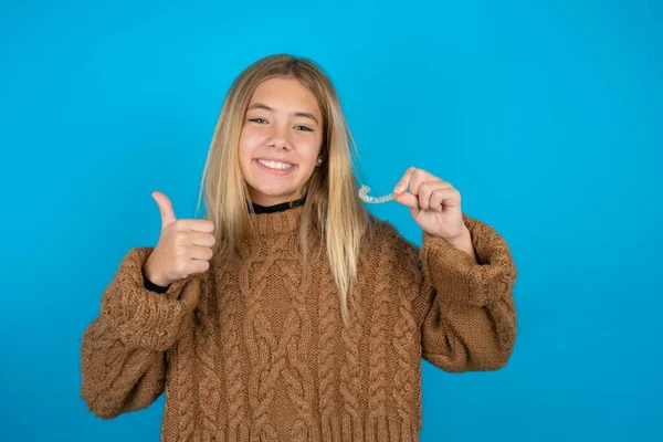 Beautiful Kid Girl Wearing Brown Knitted Sweater Holding Invisible Braces — Stock Photo, Image