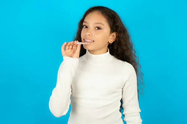 Beautiful Kid Girl Wearing White Turtleneck Blue Background Holding Invisible Royalty Free Stock Images