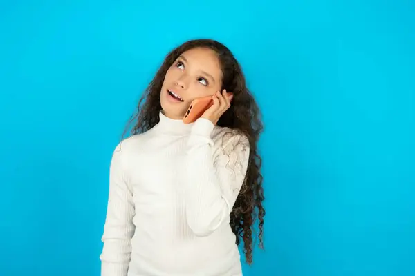Pleasant Looking Happy Beautiful Kid Girl Wearing White Turtleneck Blue Royalty Free Stock Photos