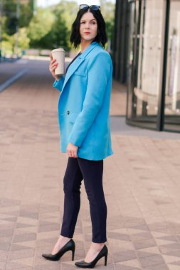 Genç zarif Asyalı profesyonel iş kadını, bayan yönetici takım elbiseli yönetici iş arasında dışarıda kahve fincanı tutuyor.. 