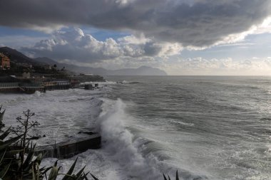 Rough sea and sky with clouds on the beach of Genoa Quinto, Italy