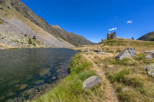 View of Guglielmo Migliorero Refuge and the lower lake of the Ischiator in the Maritime Alps in the municipality of Vinadio, in the province of Cuneo, altitude of 2094 metres, Piedmont, Italy