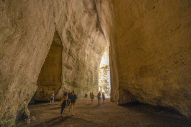 SYRACUSE, ITALY, JUNE 21, 2023 - Inside of the ear of Dionysus in Neapolis of Syracuse Archaeological Park, Sicily, Italy clipart