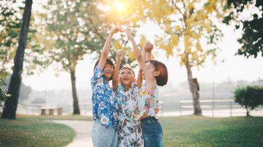 Çocuklar yazın güneşli bahçede oynarlar.