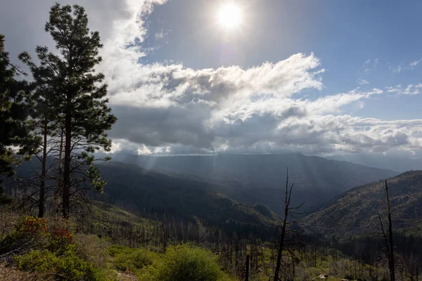 stock image Beautiful vistas of the valleys and forests of Kings Canyon and Sequoia National Park, with low clouds and blue skies