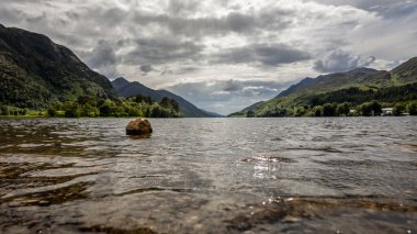 Beautiful scenery on a partly cloudy day at Loch Shiel near the Glenfinnan viaduct in Scotland clipart