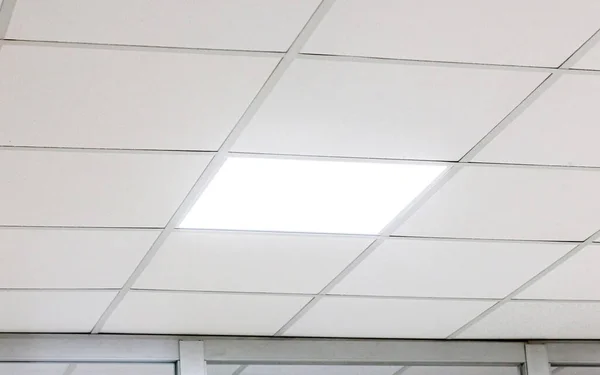 Modern design white office ceiling with led lighting.