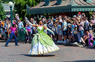 Paris, France - June 02, 2023: Show on the occasion of the 30th anniversary of Disneyland Paris. In the photo Tiana, the princess of the film The Princess and the Frog clipart