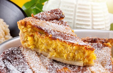 Slice of pastiera neapolitan cake dusted with icing sugar with ricotta cheese filling and a basket weave crust clipart