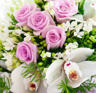 Güzel pembe güller ve beyaz orkideler zarif bir çiçek buketi şeklinde düzenlenir. Düğün veya özel bir gün için mükemmeldir.