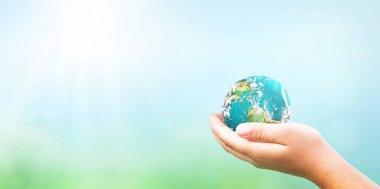 ESG concept: Human hands holding the earth against a green and ecological sustainability background, Elements of this image furnished by NASA