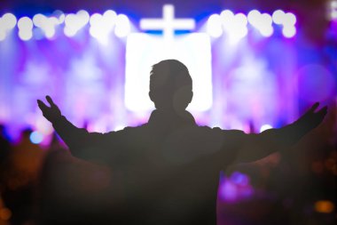 Human raised hands in blurred church service background
