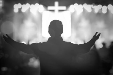 Human raised hands in blurred church service background