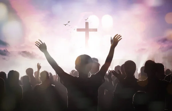 复活节和耶稣受难日的概念 许多人在日落的背景下举起双手敬拜上帝 — 图库照片