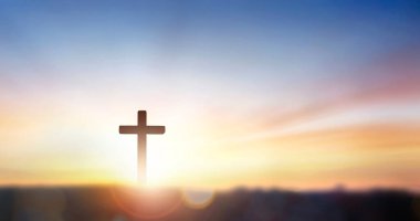 christian cross on hill outdoors at sunrise
