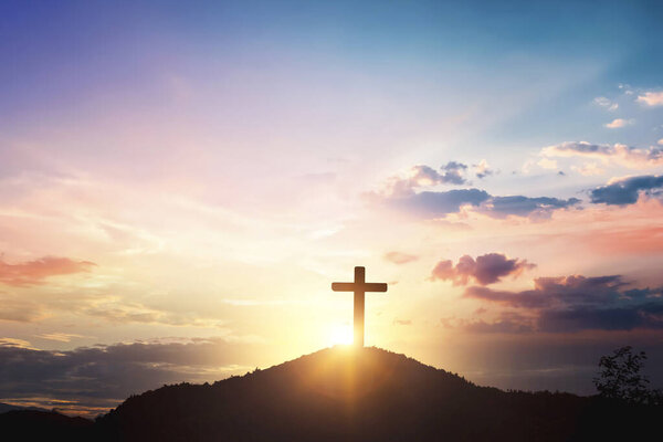 Silhouette wooden cross on mountain sunset background