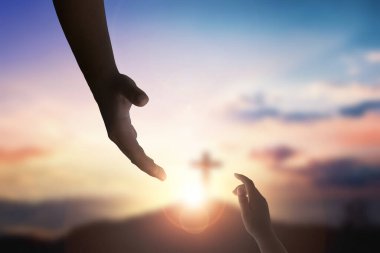 God's helping hand and cross on sunset background