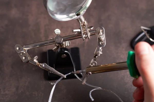 man soldering two small wires. High quality photo