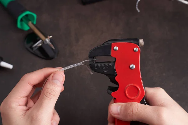man stripping cable with cable stripper. High quality photo