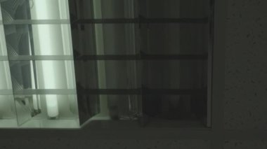 Interruptions and problems with electricity in the office. Electric fluorescent lights on the ceiling of the office flash on and off. Lack of electricity.