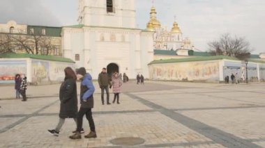 Locals and Tourists enjoy the beautiful architecture and vibrant energy of this iconic landmark in Mykhailivska Square on a crisp March day: March 1, Kyiv, Ukraine