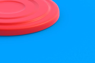 Frisbee disk on blue background. Summertime vacation. Toy for game on beach. Summer leisure. Copy space. 3d render