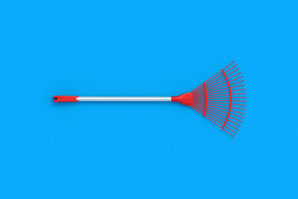 Leaf rake for leaves on blue background. Gardening equipment. Yard and lawn cleaning during fall season. Agriculture tool. Top view. 3d render