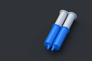 İki bileşenli epoksi reçine yapıştırıcısı. Siyah arka planda şırıngaya yapışmış. Metal için yapıştırıcı. Tamir ekipmanları. Uzayı kopyala 3d hazırlayıcı